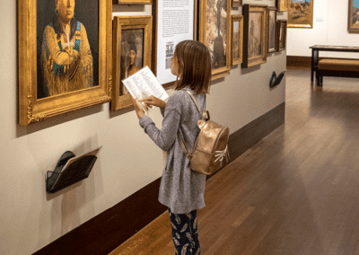 a child reading the museum guide in the Western Art Galleries