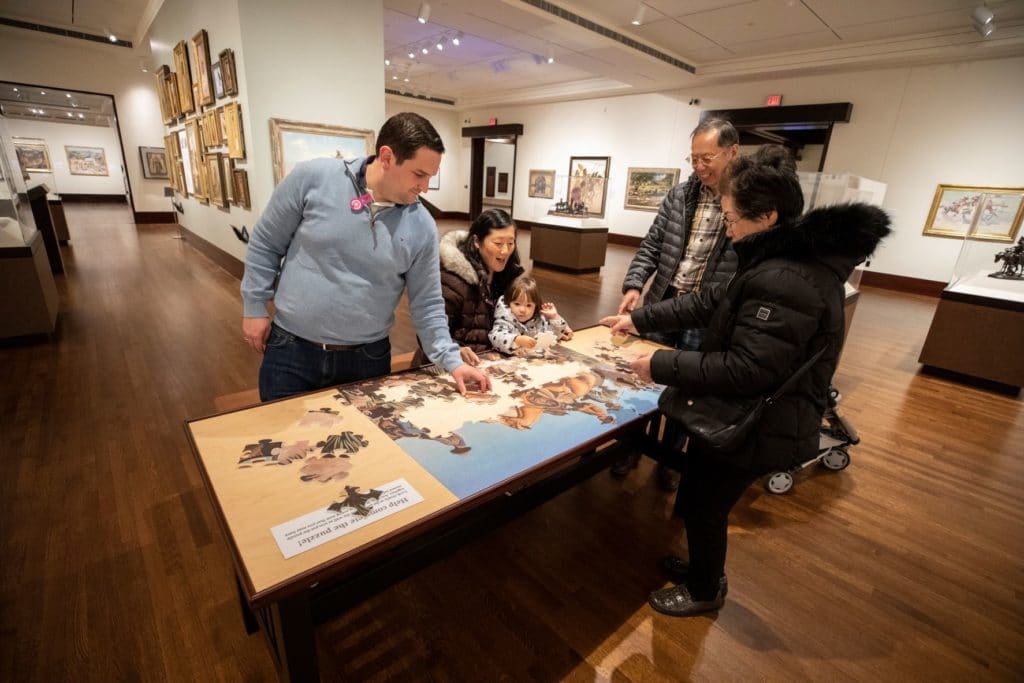 family doing a puzzle in the Western Art Galleries