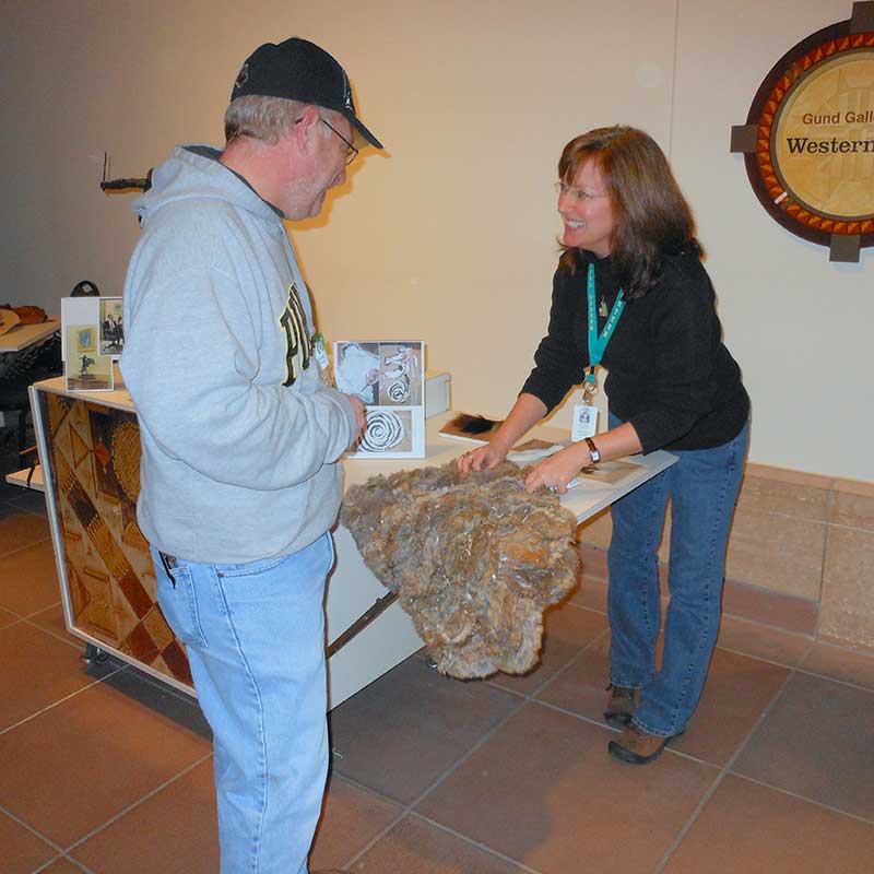 an Eiteljorg volunteer interacts with a visitor