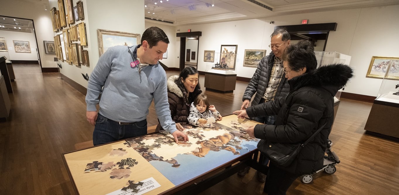 Members assembling a puzzle at the museum